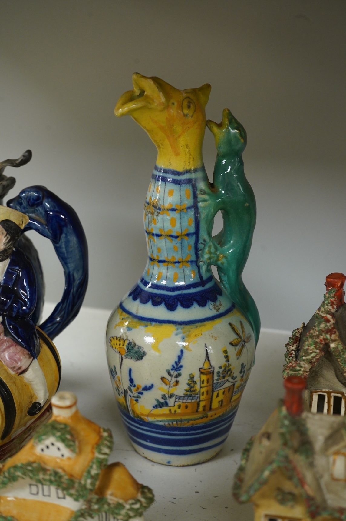 A group of various Victorian Staffordshire pottery models of cottages and various figure moulded vessels together with an Italian maiolica ewer, tallest 25cm